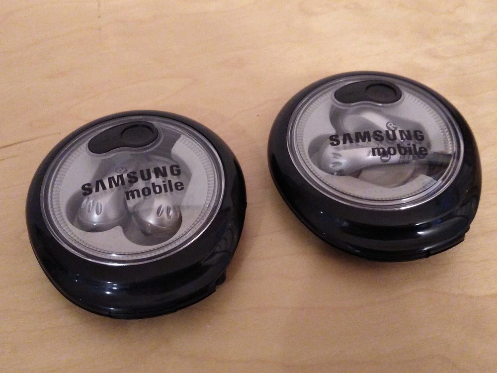 Lot of 2: Stereo In-Ear Earbuds With Windup Case.