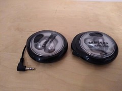 Lot of 2: Stereo In-Ear Earbuds With Windup Case.