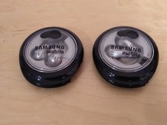 Lot of 2: Stereo In-Ear Earbuds With Windup Case.