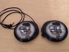 Lot of 2: Stereo In-Ear Earbuds With Windup Case.